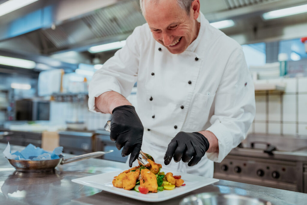 Helmut beim Backhendlsalat anrichten